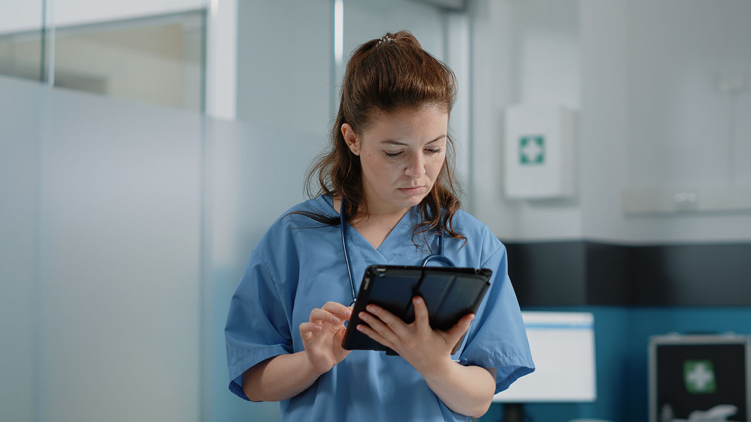 Veterinary field technician using an iPad on the job