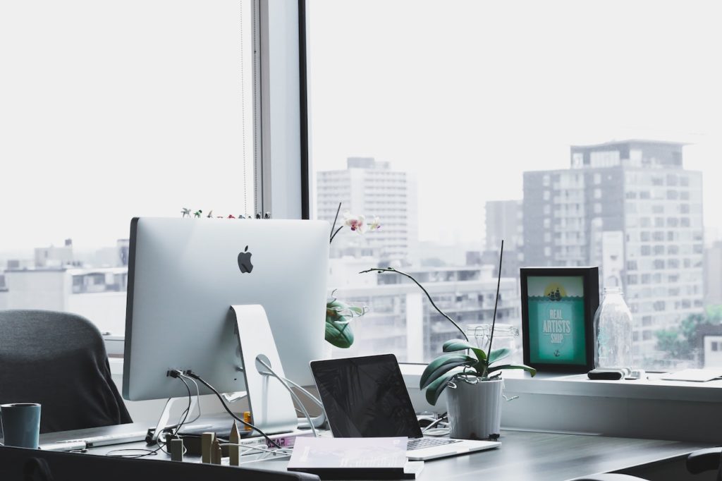 business hardware shown on desk by window showing city skyline